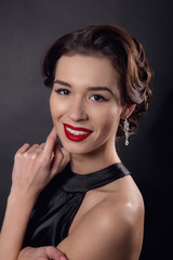 Beautiful gorgeous woman with elegant wavy hairstyle, bright make up.