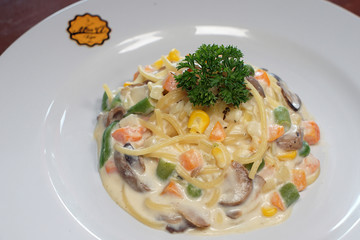 Fettucini pasta with vegetables smothered in cheese sauce