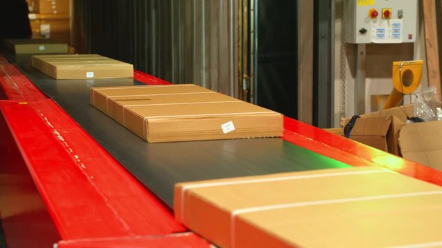 Packages on a Conveyor Belt in a Warehouse 