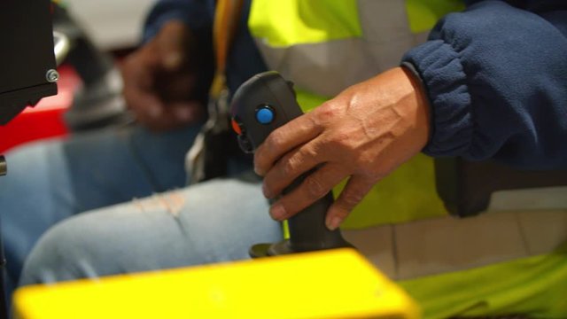 Close Up / Hand of Warehouse Worker operating Handle of Machine 