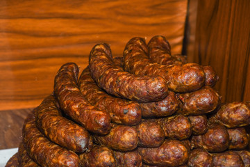 Many homemade German mix of meat specialties, speck ham sausages pile or stack on counter top