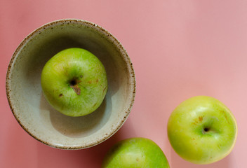 Fresh juicy green apples on pink background. Apples on pink.