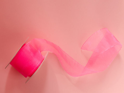 Pink capron ribbon on pink background. Pink stripe.