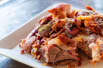 Roasted pork leg on a white dish