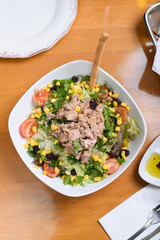 mixed salad with fish, tomatoes, lettuce, cucumber, red pepper, ready to serve