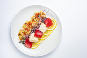 Healthy food on a white plate and a white background.