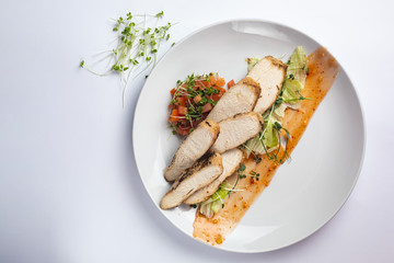 Healthy food on a white plate and a white background.