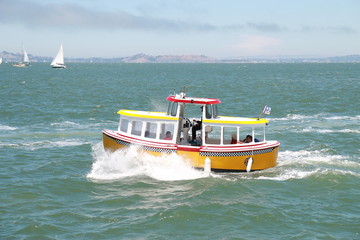 Fototapeta premium yellow small boat sailing in the sea