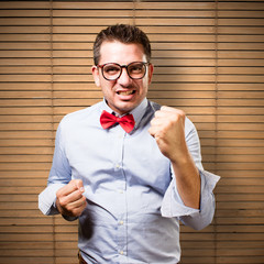 Man wearing a red bow tie. Looking upset.