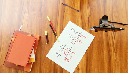 Notebooks, pens and prepared written class notes of teacher with mobile on table after virtual class - concept of virtual teaching, work from home during coronavirus or covid-19 crisis.