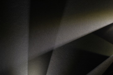 light prism with beams on dark textured background