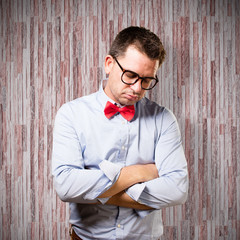 Man wearing a red bow tie. Looking tired.