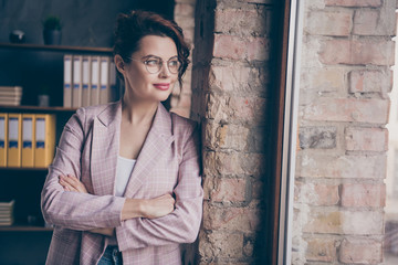 Obraz premium Portrait of her she nice attractive pretty smart clever experienced dreamy businesslady looking at window folded arms at modern industrial loft brick style interior work place station