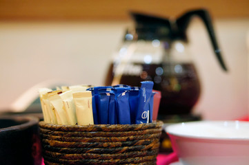 Sugar and creamer sachets on the coffee table
