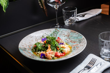 Prawn salad view from above in a deep plate against the background 