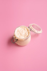 Sourdough starter jar. Mature mother dough. Making bread ingredient