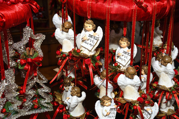 Christmas tree ornament decoration red ribbons and cute little angels for hanging in the tree