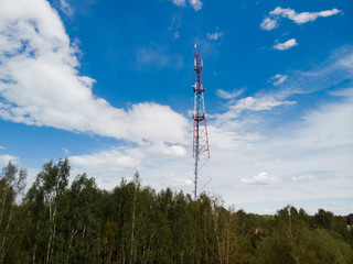 4G and 5G GSM telecommunications tower with blue sky background aerial view