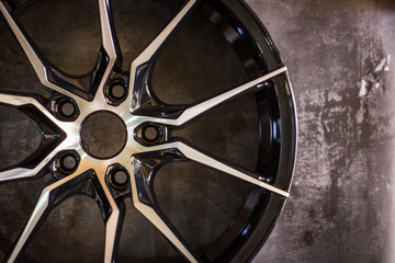 Luxury chrome alloy wheel in close-up as an automotive background.  Close up shot of a new car rim.