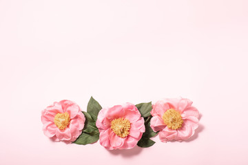 Flatlay of gift card on pink backdrop. Floral background. Spring summer concept background. Flat lay, top view.