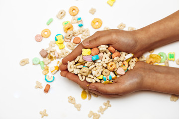 Women's hands on a white background hold assorted cookies, sweets, and corners .