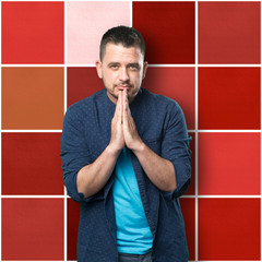 Young man wearing a blue outfit. Look praying.