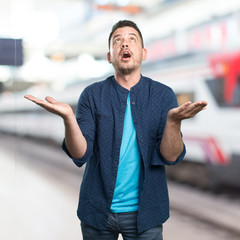 Young man wearing a blue outfit. Look praying.