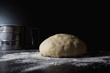 Fototapeta na wymiar pizza dough sprinkled with wheat flour