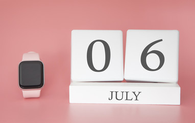 Modern Watch with cube calendar and date 06 july on pink background. Concept summer time vacation.