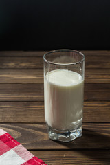 glass of milk on a wooden table.