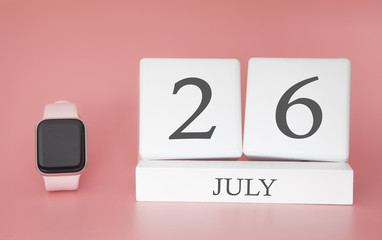 Modern Watch with cube calendar and date 26 july on pink background. Concept summer time vacation.