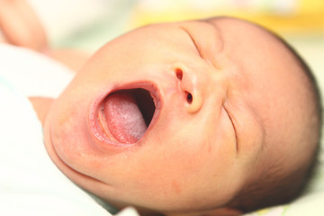 Fototapeta premium cute asian baby yawning close up