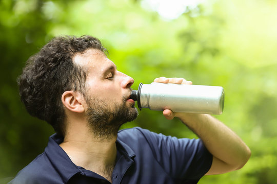 Sports activity during coronavirus. Runner wearing a medical mask, Covid-19 pandemic. Active life in quarantine, protection for face mask. Outdoor ride on countryside.