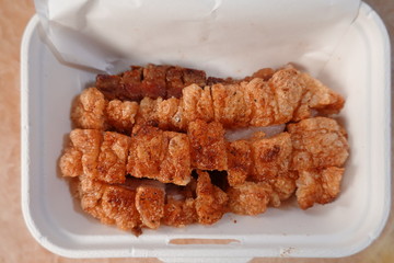 traditional Thai culture air fryer fried pork cuisine style or moo tod krob favorite famous street fast foods menu at thailand homemade
with hot spicy sauces on table wood dish sticky rice vegetable