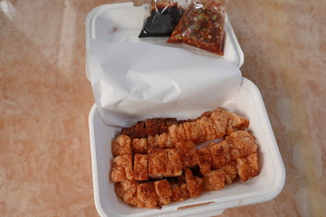 traditional Thai culture air fryer fried pork cuisine style or moo tod krob favorite famous street fast foods menu at thailand homemade
with hot spicy sauces on table wood dish sticky rice vegetable