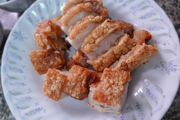 traditional Thai culture air fryer fried pork cuisine style or moo tod krob favorite famous street fast foods menu at thailand homemade
with hot spicy sauces on table wood dish sticky rice vegetable