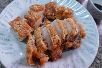 traditional Thai culture air fryer fried pork cuisine style or moo tod krob favorite famous street fast foods menu at thailand homemade
with hot spicy sauces on table wood dish sticky rice vegetable