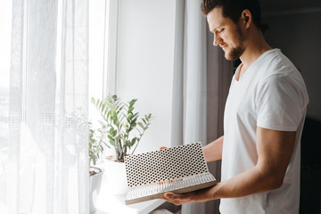 Man holding in hands bed of nails and preparing for morning yoga practice. Mindfulness and alternative medicine concept.