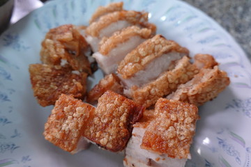 traditional Thai culture air fryer fried pork cuisine style or moo tod krob favorite famous street fast foods menu at thailand homemade
with hot spicy sauces on table wood dish sticky rice vegetable