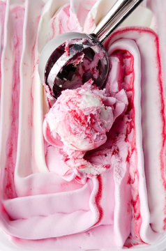 Vertical image.Delicious frozen ice cream with topping and scoop
