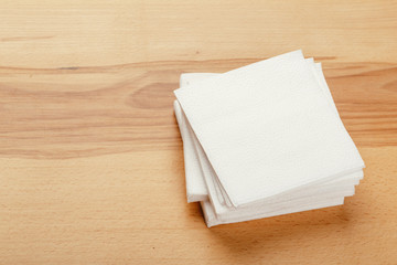 white paper napkin or tissue on the wooden table background.