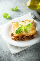 Traditional homemade lasagna served with fresh basil