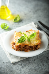 Traditional homemade lasagna served with fresh basil