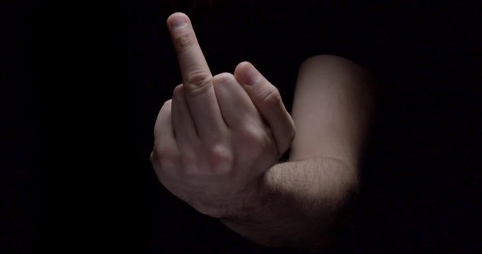 Hand Giving Middle Finger. Black Background. Flipping A Bird