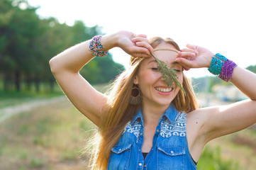 horizontal closeup portrait of a cheerful hippie on nature background