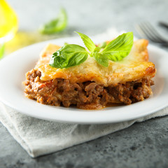 Traditional homemade lasagna served with fresh basil