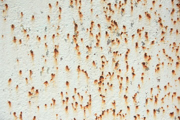 iron panel painted white with rust spots