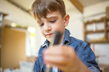 Cute Boy using a screwdriver	
