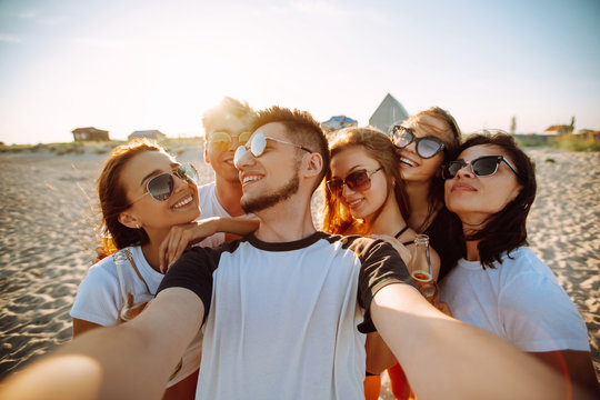 Group of young friends taking selfie and having fun on  the beach. Summer holidays, vacation, relax and lifestyle concept.
