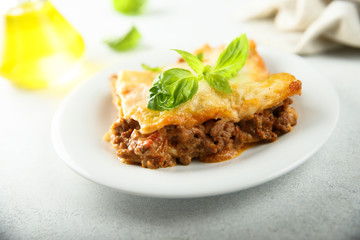 Traditional homemade lasagna served with fresh basil